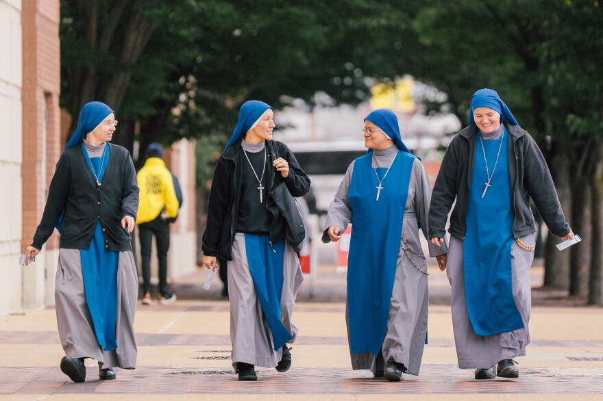 Sisters with the Servants of the Lord and the Virgin of Matará walk near the Dome at America's Center ahead of the beatification Mass for the late Archbishop Fulton J. Sheen on Thursday in downtown St. Louis.