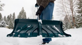 A man shovels snow. He's probably around the middle one of all the stages of rage, we figure. Though if he were sobbing, you couldn't see it.