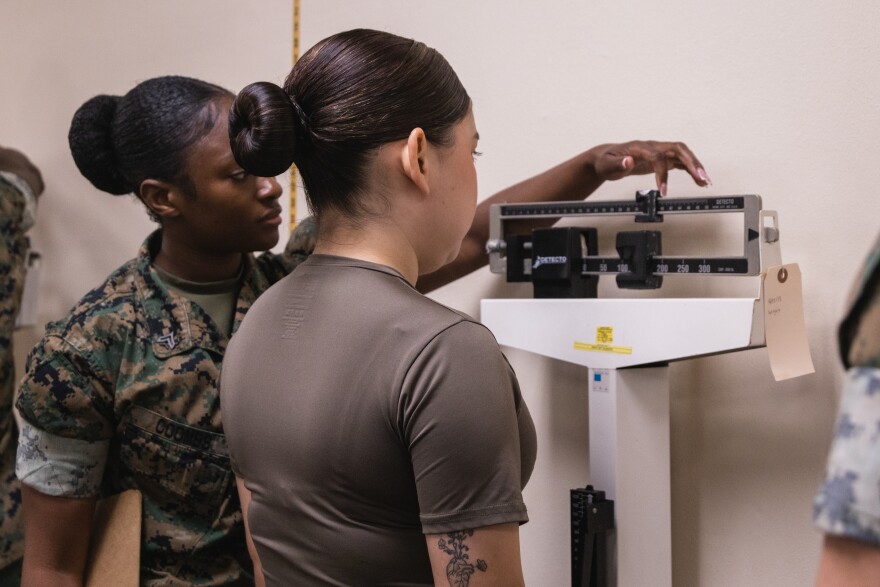 A U.S. Marine is weighed during an April 2025 commanding general’s readiness inspection at Camp Kinser in Okinawa, Japan.