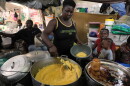 FILE - A woman sells food at a shelter for families displaced by gang violence in Port-au-Prince, Haiti, Aug. 17, 2026.