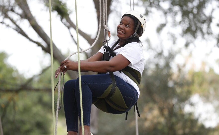 Festival attendees participate in tree climbing during the 2022 Publix Tampa Bay Collard Festival in St. Petersburg, Florida, on Saturday, February 19, 2022. Photo by Octavio Jones for WUSF