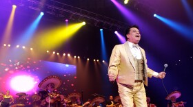 Man performs in front of mariachis