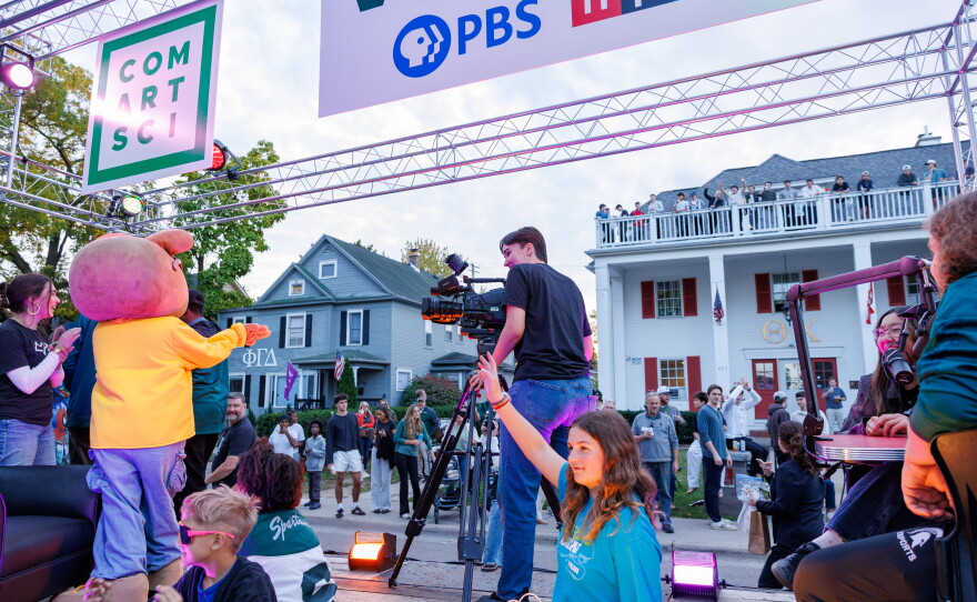 Excited attendees of the Michigan State University Homecoming Parade react to PBS KIDS character Arthur riding on the WKAR float in East Lansing, Mich., on Oct. 9, 2026.