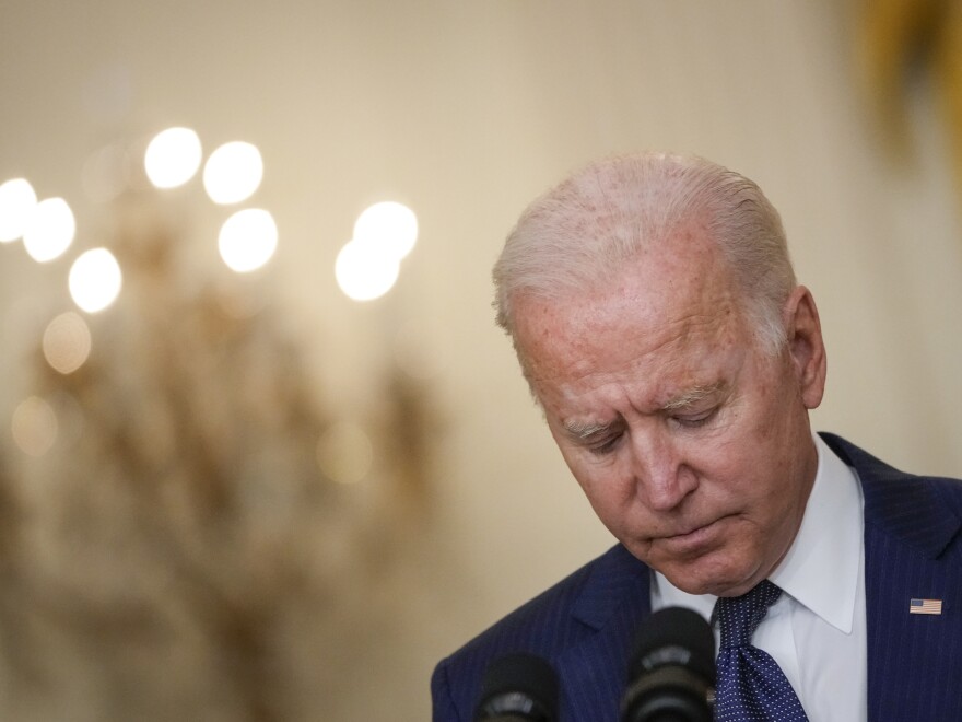 President Biden bows his head in a moment of silence as he speaks about the situation in Kabul, Afghanistan from the East Room of the White House on Aug. 26, 2021.