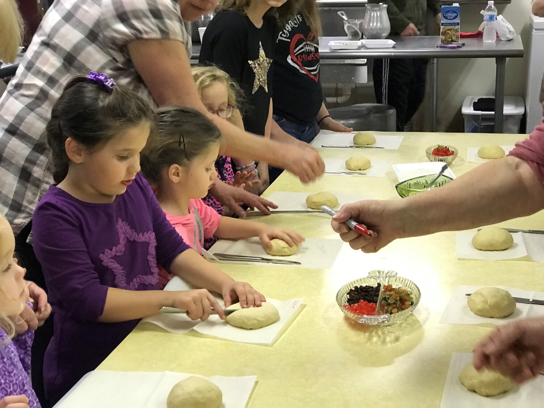Children and their families making grittibanz in Helvetia, W.Va. for the Feast of Saint Nicholas. Dec. 1, 2018.