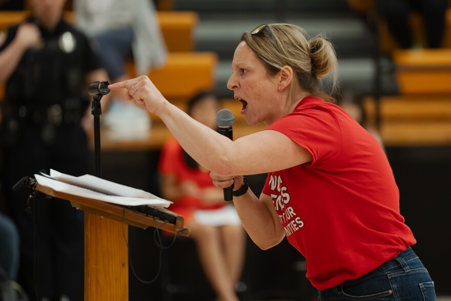 Festus resident Erica Carter calls for a recall of the city's mayor and for a "lawyer to clean this s*** up" while testifying against a plan to develop a large-scale data center in the rural community on Monday night.