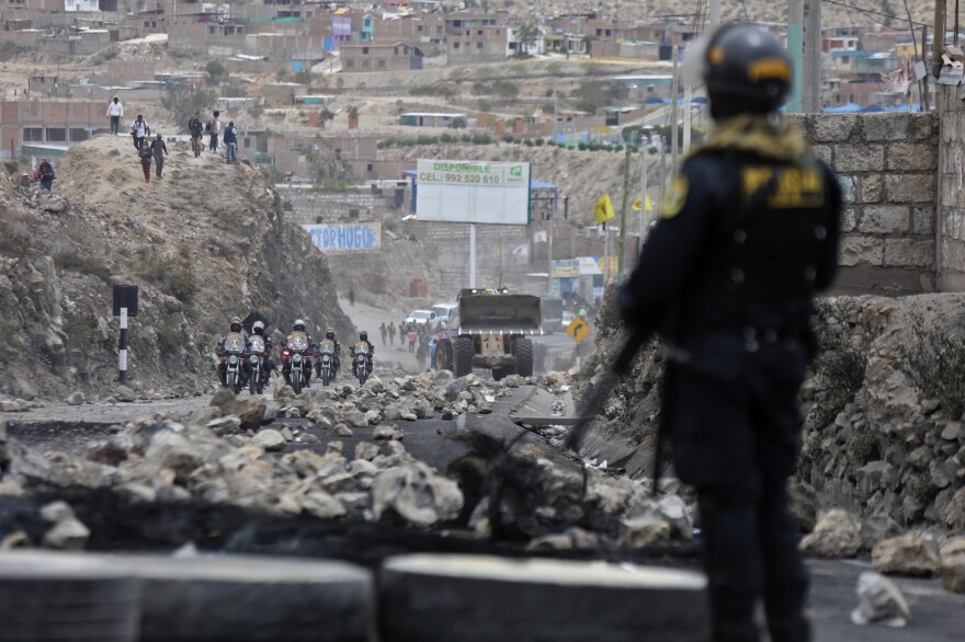 Police arrive to clear debris from a highway, placed by supporters of ousted Peruvian President Pedro Castillo protesting his detention in Arequipa, Peru, on Thursday.