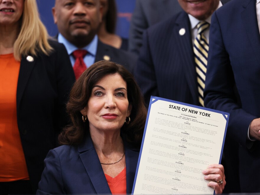 New York Gov. Kathy Hochul announced that she is pledging $10 million to establish new teams in every county and in New York City dedicated primarily to combat domestic terrorism. Here, Hochul holds up signed legislation as she is surrounded by lawmakers during a bill signing ceremony at the Northeast Bronx YMCA on June 6, 2022 in New York City.