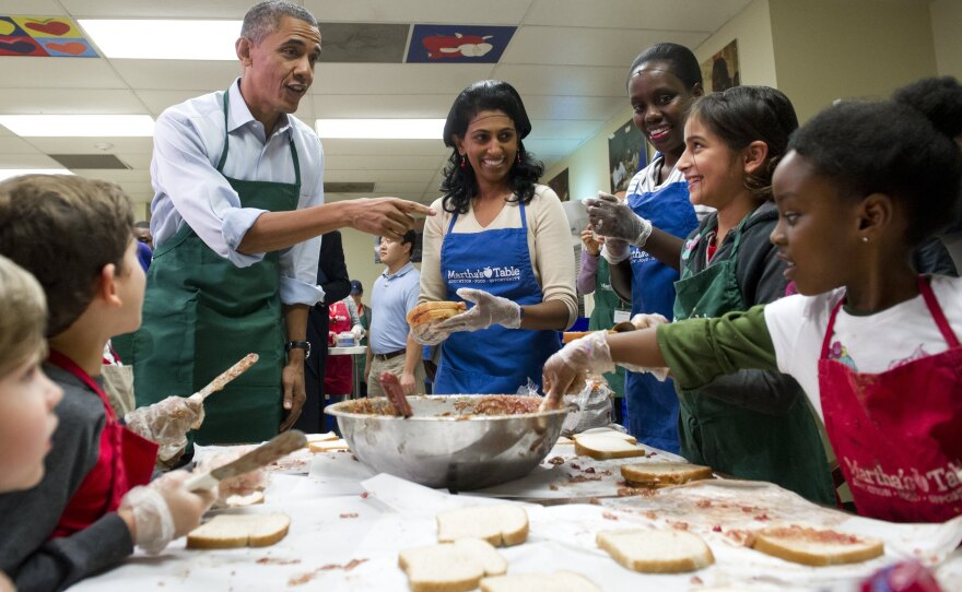 President Obama talks with children and adult volunteers at Martha's Table in Washington, D.C., on Monday. The nonprofit organization helps low-income and homeless families. Many of the volunteers over the past couple weeks were furloughed federal workers.