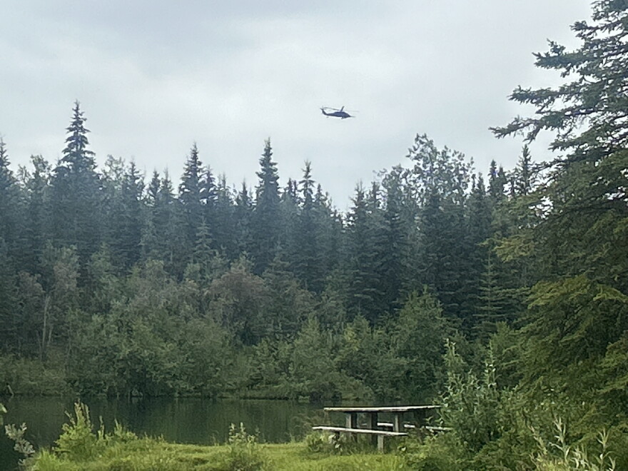 A helicopter passes over a military recreation area outside of Eielson Air Force Base near Fairbanks, Alaska.