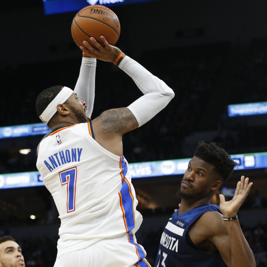 Oklahoma City Thunder's Carmelo Anthony shoots over Minnesota Timberwolves' Jimmy Butler during a game Friday in Minneapolis. The Thunder had a rocky flight to Chicago after the game.