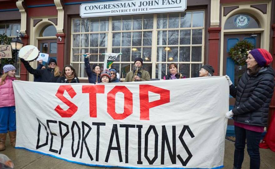 Activists rally outside Congressman John Faso's Kinderhook office.