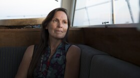 Deborah Alexander, one of the many people who were tribally disenrolled from the Nooksack tribe, looks out of the window of a safety boat during the first leg of a canoe journey on Thursday, July 27, 2017, in Point Roberts.