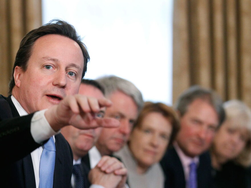 Britain's new prime minister, David Cameron, makes a point at the first Cabinet meeting of his new coalition government. The new ministers began by giving themselves a pay cut.