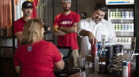 State Rep. Eddie Rodriguez of Austin buys beer to go from Zilker Brewing Company on Sunday, the day a new law allowing the sale in Texas went into effect.