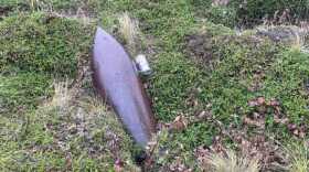 Military officials say an artillery shell found near Cold Bay in October 2023 was approximately 12 inches in diameter and four feet long (soda can for reference. (Courtesy Harold “Hap” Kremer)