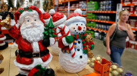 A woman walks by Christmas merchandise offered for sale in October at a Home Depot in Niles, Ill. Analysts predict the troubled economy will result in flat retail sales this holiday season.