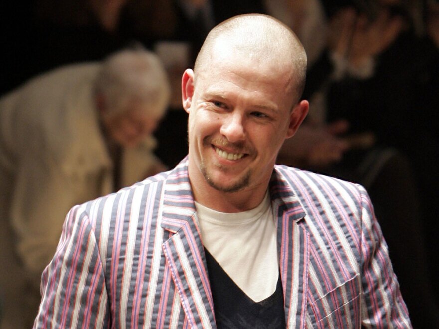 British fashion designer Alexander McQueen acknowledges applause after a March 2006 show in Paris.