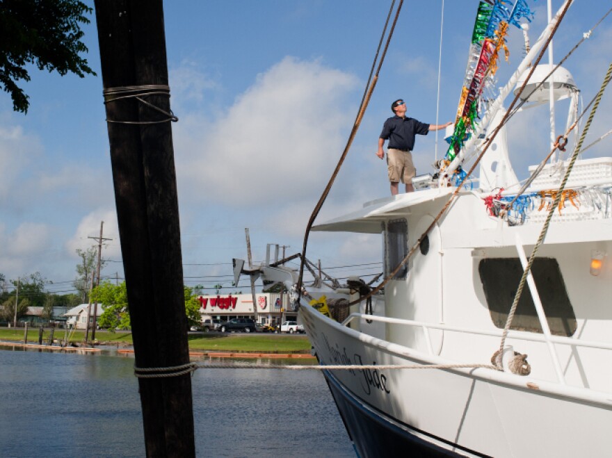 David Chauvin pauses to inspect the decorations on his trawler, the Mariah Jade.