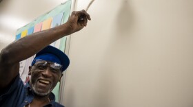 Daniel Williams, rings a bell at Pacific House in Stamford, a celebration performed when a resident of the men's shelter secures housing.