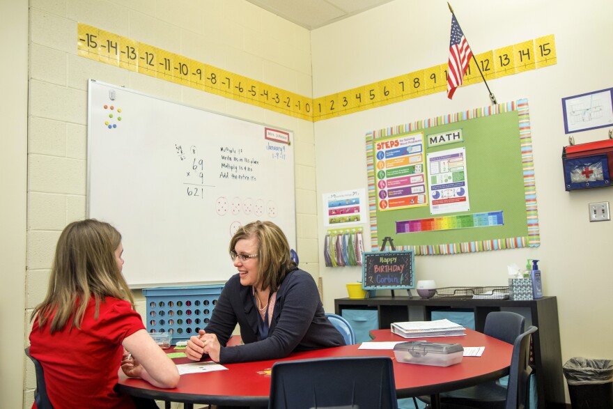 Stephanie Johnson works with a student at the Renaissance Academy, a charter school in Lehi, Utah.