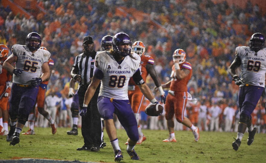East Carolina tight end Bryce Williams (80) catches a touchdown pass in the fourth quarter as rain begins to fall in the Swamp.
