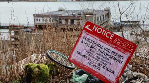 A sign at the proposed site for a 72-unit apartment building in downtown Juneau. The project was approved for a conditional land-use permit by the city planning commission on Dec. 12, 2023.