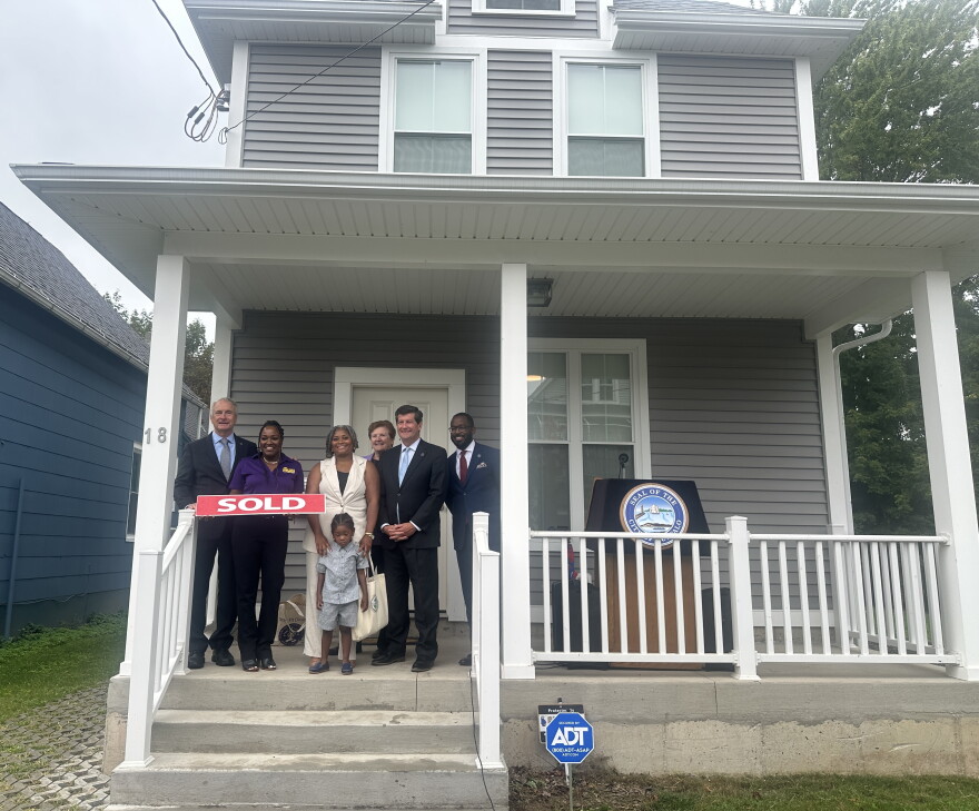Walton family joined by City Officials as they celebrate the first home sold under the Building Buffalo Roots program