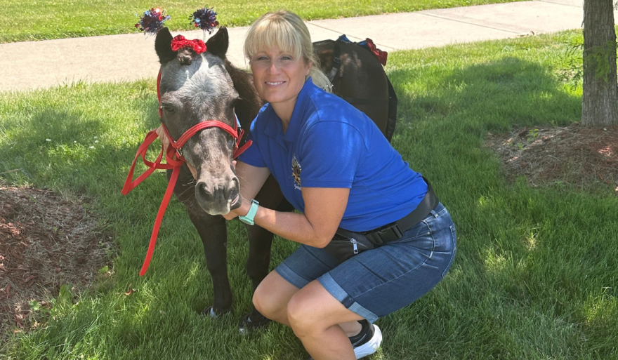 Heather Bowman, author of "There's a Horse in my House" stands next to Fabio the horse.