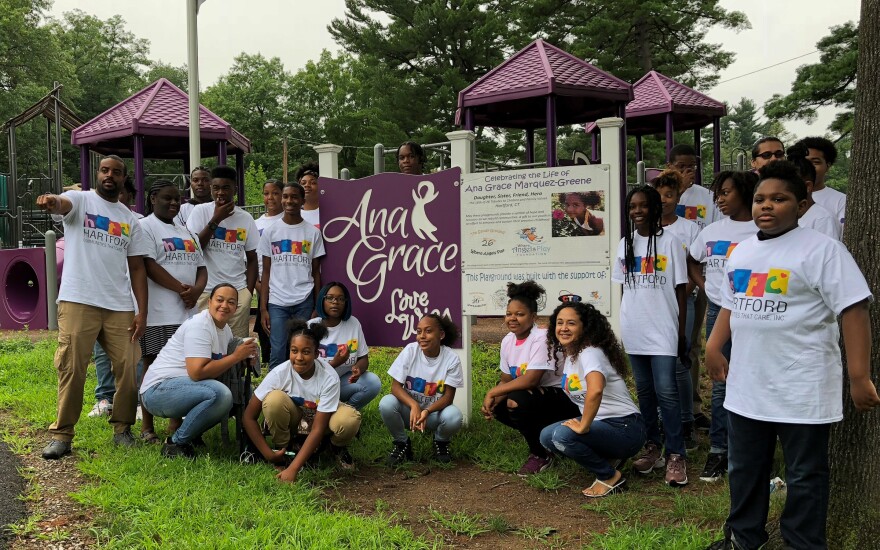 Members of the Greater Hartford Youth Leadership Academy take a photo with Nelba Marquez-Greene, kneeling at right, before boarding a bus headed to a rally in Newtown, Conn. Marquez-Greene's daughter Ana died in the Newtown school shooting.