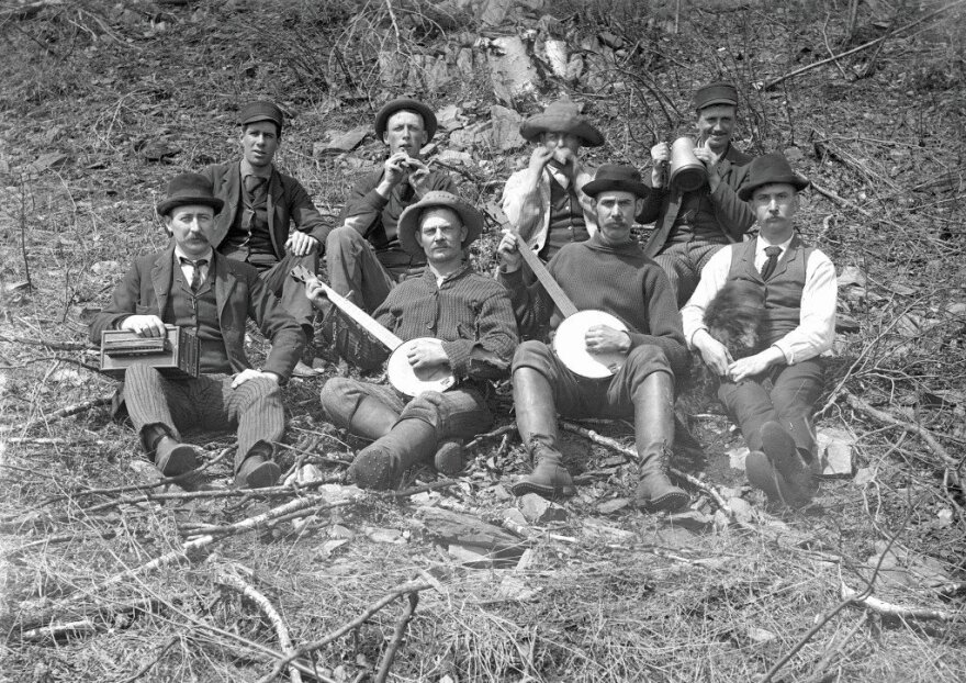 Group of men sitting on a hill