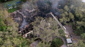 Firefighters work to extinguish the remains of a fire at a home owned by Miami Heat basketball coach Erik Spoelstra, Thursday, Nov. 6, 2025, in Miami. (AP Photo/Rebecca Blackwell)