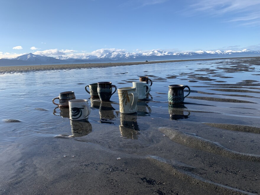 A collection of mugs by participating artists showcases the diversity of creative voices on the tour.