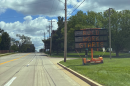 Construction signs are in place for the Fox Creek Road project, which will expand the roadway to five lanes and bridge a gap in the Constitution Trail for pedestrians and cyclists.
