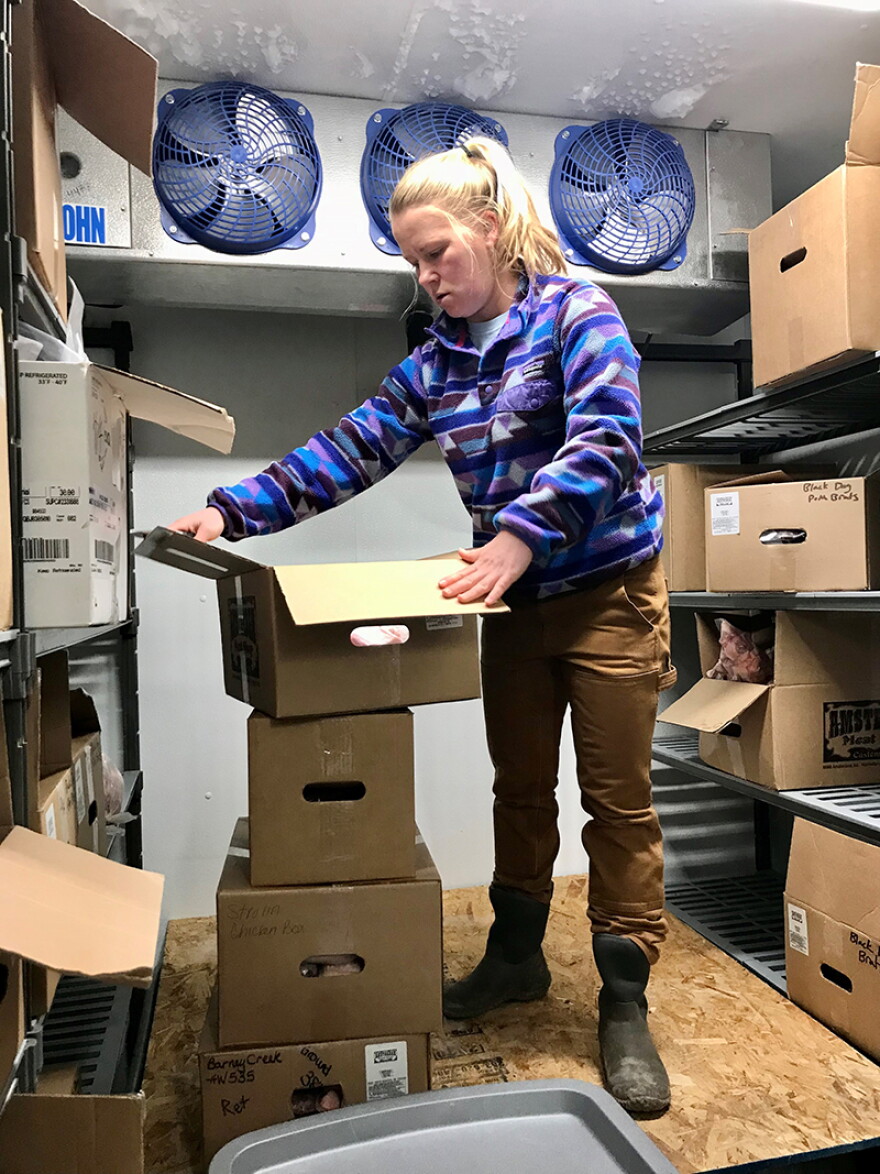 Kira Jarosz working in the freezer at Black Dog Farm in Livingston