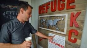 Richard Casebolt, the founder of Refuge KC, points out one of the many words translated to say "welcome" on a sign near his office in northeast Kansas City. The agency assists resettled immigrants with a variety of services with the aim of making them welcome in their new surroundings.