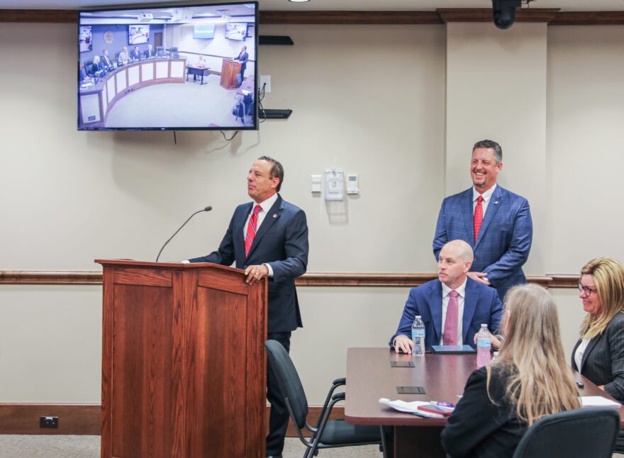 University of Oklahoma President Joseph Harroz, Jr., speaks Tuesday to the Oklahoma Turnpike Authority as OTA Executive Director Joe Echelle, standing right, looks on.