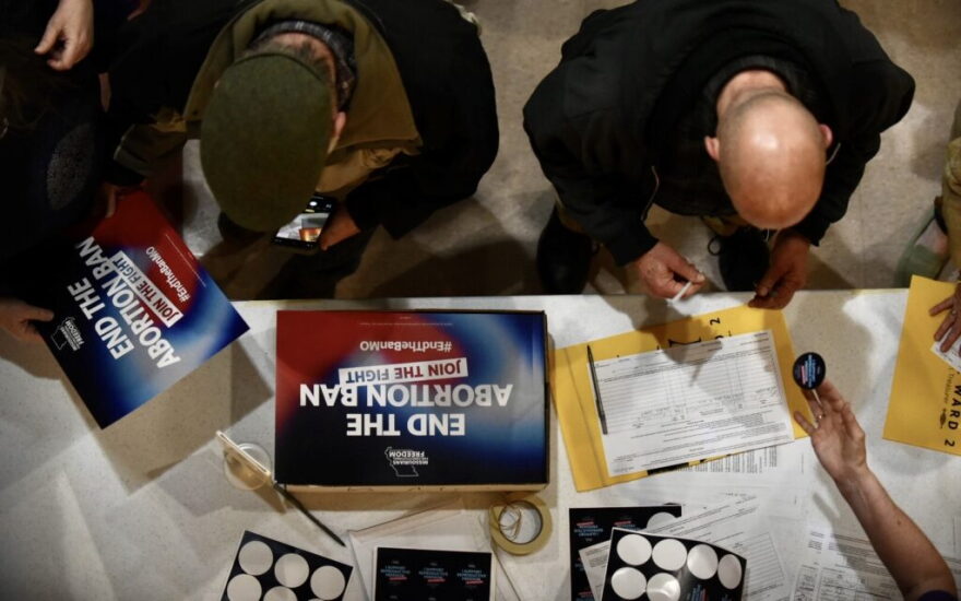 Supporters sign an initiative petition in support of a ballot measure that would legalize abortion up to the point of fetal viability in Missouri. during an event on Feb. 6, 2024, in Kansas City hosted by Missourians for Constitutional Freedom (Anna Spoerre/Missouri Independent).