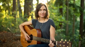 Jaspar Lepak playing guitar in the woods