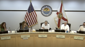 City council members sit in chairs