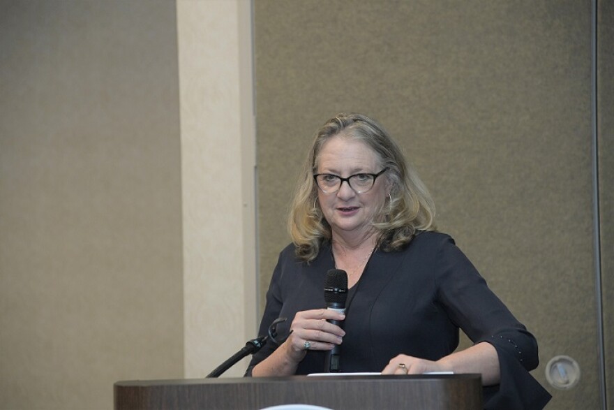 FAF President Barbara Petersen stands behind a podium with a microphone as she addresses the Florida Associated Press Broadcasters awards gala in Orlando on April 13, 2019.