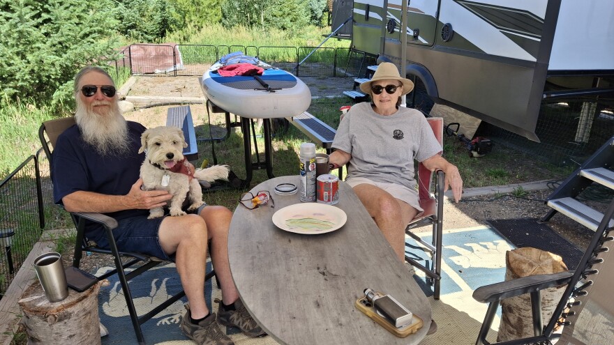 Shane and Jan Tucker, along with their dog, Percy, at their campsite at Pearl Lake in Routt County, Colorado. The couple has spent the past five summers volunteering as camp hosts at the state park in northwest Colorado.