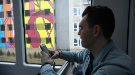 Michael Fleming takes a photo of his NoDa apartment building from the Blue Line light rail train during a test ride Tuesday. 