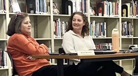 Karen Beverlin (left) and Lindsay Winter chat Wednesday before a special meeting of the Washington Community High School board. Winter is the high school's administrator for instructional data and research.