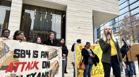 Kristin Etter, director of policy and legal services at the Texas Immigration Law Council, talks to opponents of Senate Bill 4 outside the federal courthouse in Austin on Thursday, February 15, 2024.