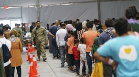 Afghan refugees line up for food in a dining hall at Fort Bliss' Doña Ana Village, in New Mexico, where they are being housed, Friday, Sept. 10, 2021. The Biden administration provided the first public look inside the U.S. military base where Afghans airlifted out of Afghanistan are screened, amid questions about how the government is caring for the refugees and vetting them.