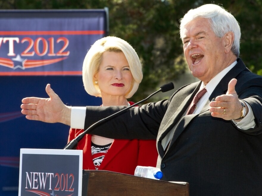 Republican presidential hopeful Newt Gingrich, with his wife, Callista, delivers remarks Sunday during a rally with senior citizens at The Villages retirement community in Lady Lake, Fla.