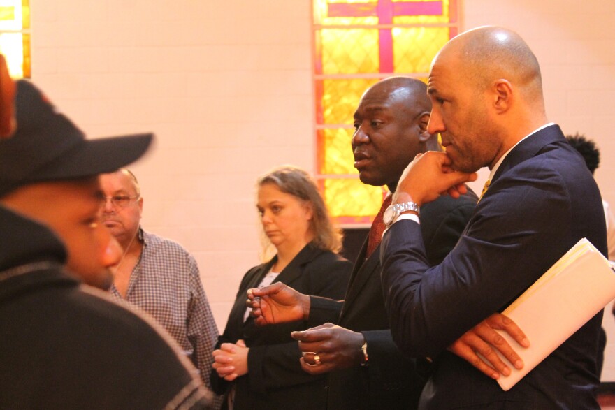 Attorneys Benjamin Crump (speaking) and Mike Laux speak with participants before Tuesday's press conference about no-knock raids.