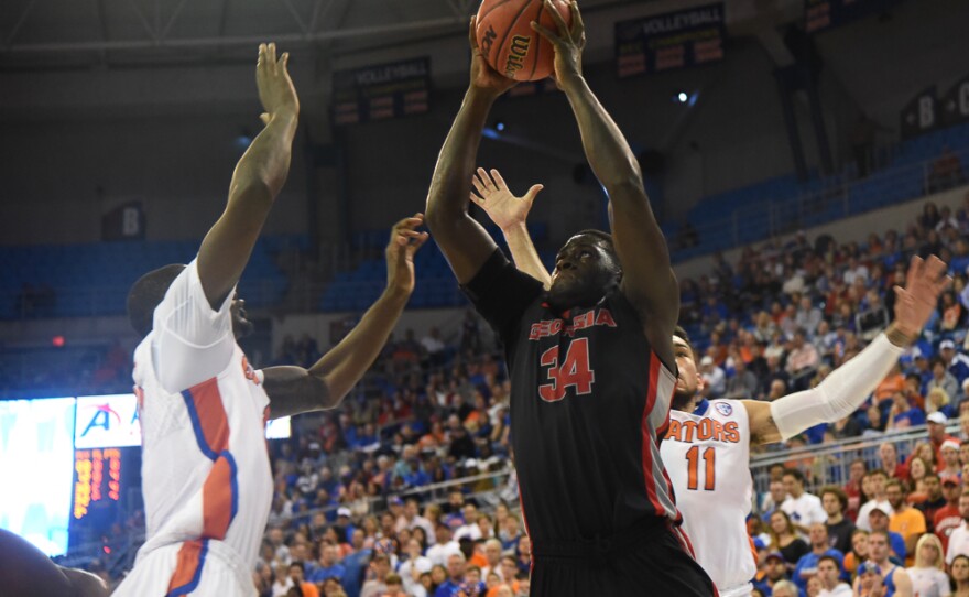 Georgia's Derek Ogbeide (34) takes the ball up for a two-handed slam dunk in the first half. (Greenberry Taylor/WUFT News)