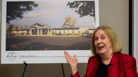 Kimberly McClanahan, executive director of the Valley Community Services Board, displays an artistic rendering of the Valley Recovery and Assessment Center being built in Fishersville.